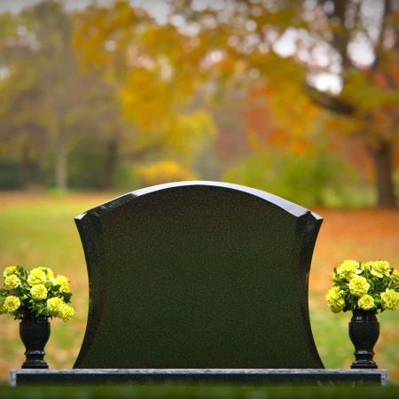 Waved granite headstones with dual flower vases for elegant tribute.