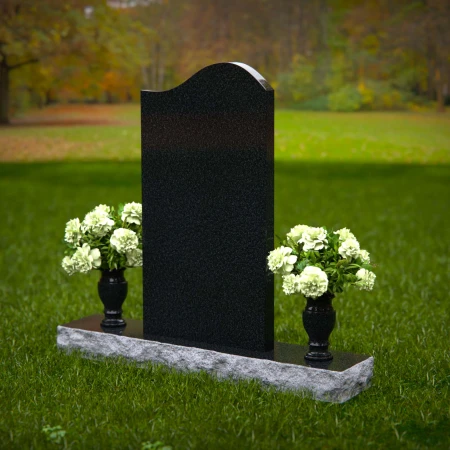 Elegant upright headstones with floral arrangement for timeless tribute.