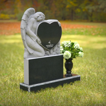 Granite angel heart headstones with floral vases for loving memorials.