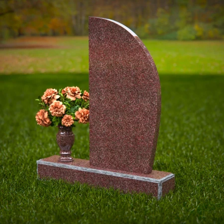 Contemporary headstones featuring sleek curves and floral vases.