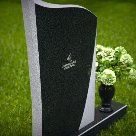 Modern headstones featuring flowing curved design and floral vases.