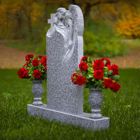 1911 - Angel Monument Embracing Cross with Floral Tributes