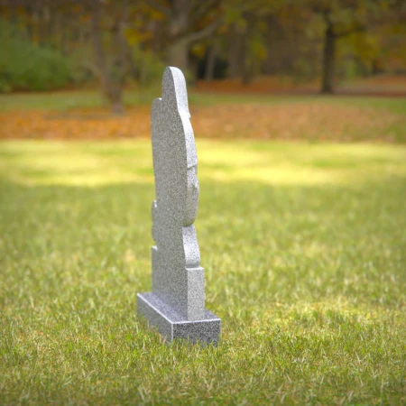 Heart-shaped gray granite headstone with angel design — a touching memorial tribute.