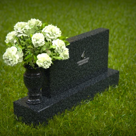 Elegant headstones featuring custom memorial designs and flower vases.