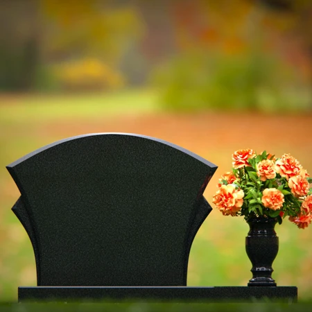Unique headstones featuring artistic arch designs and floral vases.