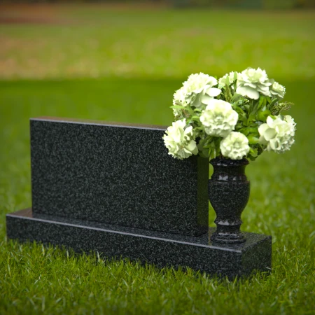 Elegant headstones featuring custom memorial designs and flower vases.