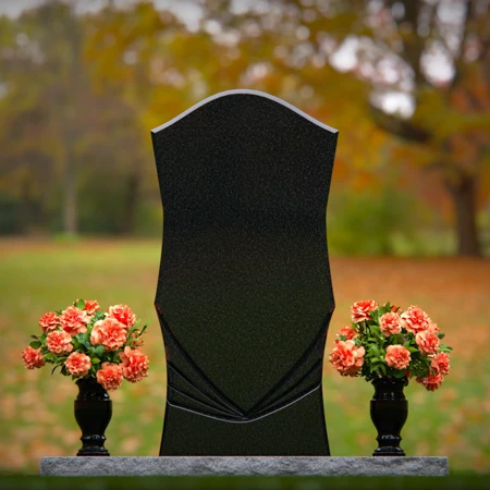 Elegant headstones with unique contours and dual flower vases.