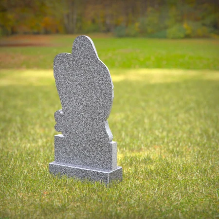 Heart-shaped gray granite headstone with angel design — a touching memorial tribute.