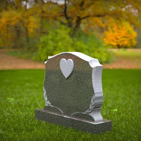 Memorial artistry flows through heart and leaf designs in headstones