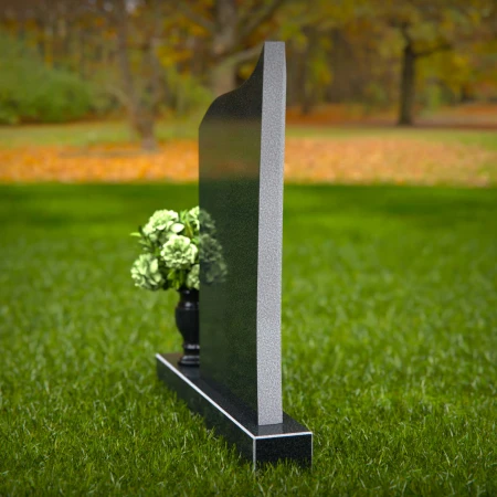 Modern headstones featuring flowing curved design and floral vases.
