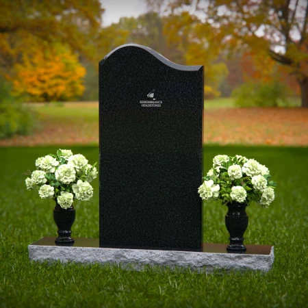 Elegant upright headstones with floral arrangement for timeless tribute.