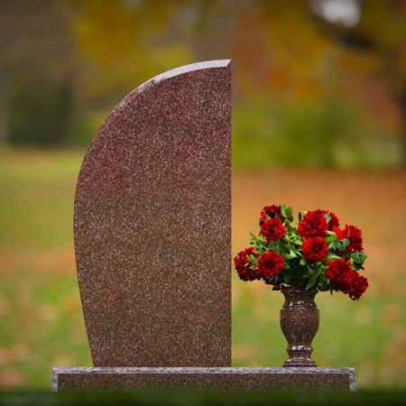 Contemporary headstones featuring sleek curves and floral vases.