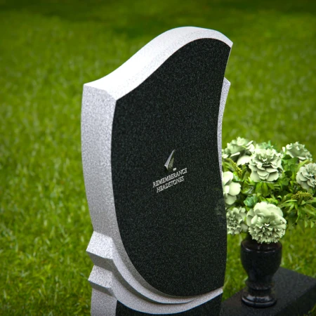 Elegant granite headstones with curved design and flower vase.