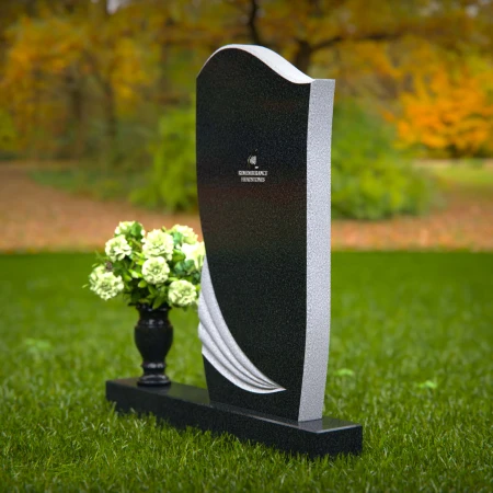 Artistic headstones with unique curved design and flower vase.