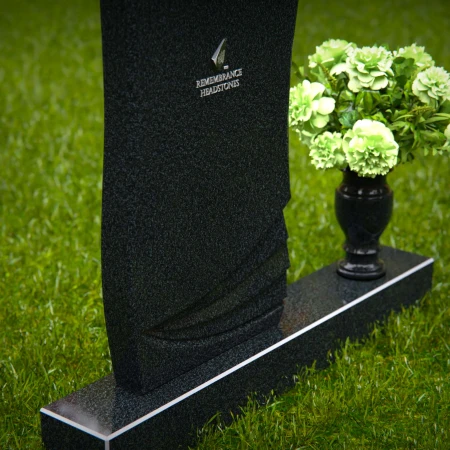 Elegant curved granite headstones with layered detailing for timeless memorials.