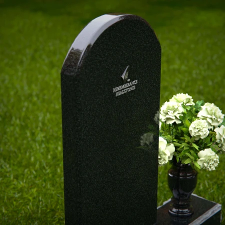 Classic arched headstones with a single flower vase for tribute.