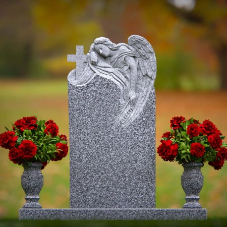 1911 - Angel Monument Embracing Cross with Floral Tributes