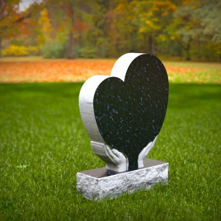 Comforting headstones with sculpted hands gently cupping heart