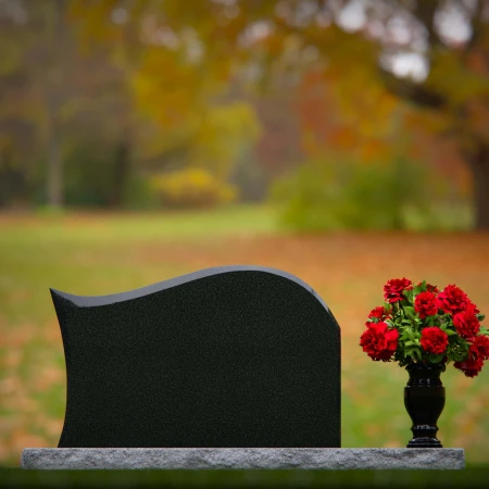Modern waved granite headstones with flower vase for peaceful tribute.