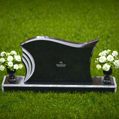 Elegant curved headstones with artistic detailing for a timeless tribute.