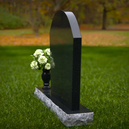 Arched granite headstones with elegant form and flower vase.