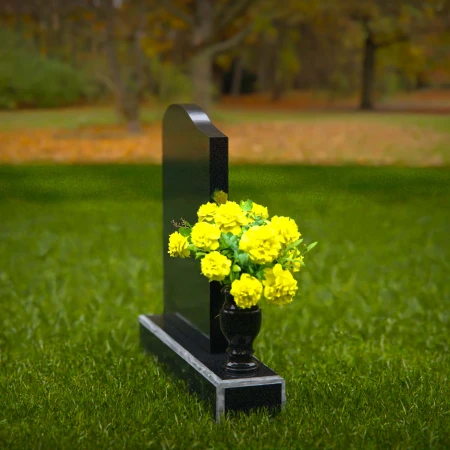 Elegant granite headstones with gently curved top and flower vase.