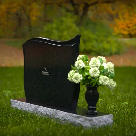Contoured granite headstones with polished finish and flower vase.