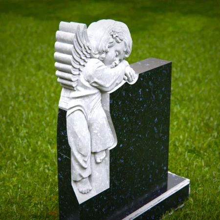 Carved children’s headstones with quiet angel watching over