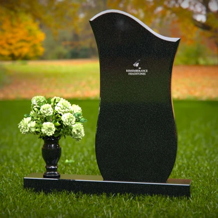 Contemporary granite headstones with unique curved design and vase.