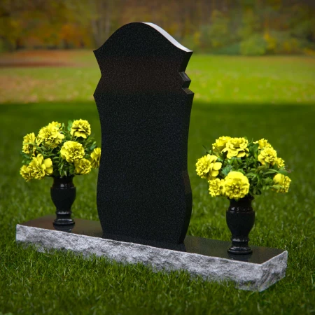 Unique shaped headstones with dual flower vases for memorial tribute.