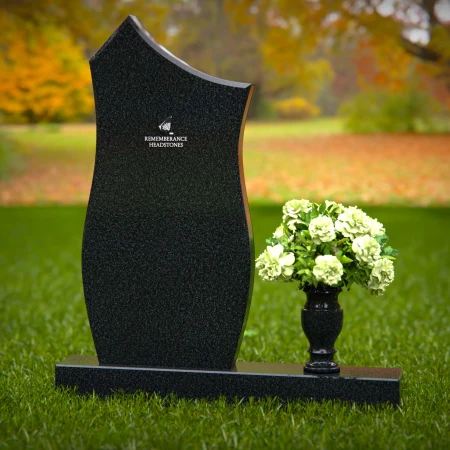 Modern contoured granite headstones with single flower vase.