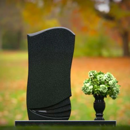 Elegant curved granite headstones with layered detailing for timeless memorials.