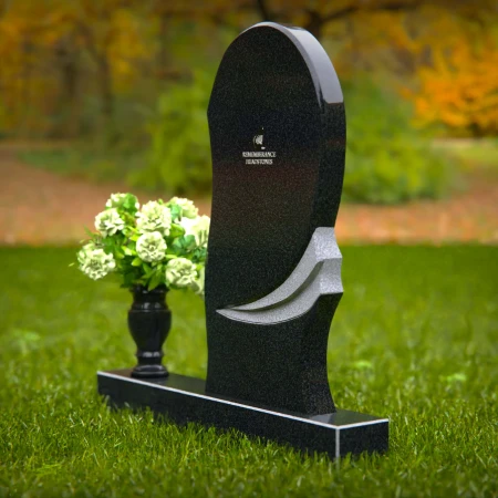 Contemporary headstones with curved artistic design and floral vase.