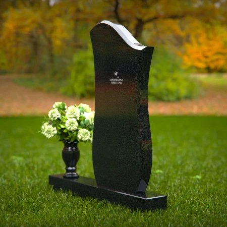 Contemporary granite headstones with unique curved design and vase.