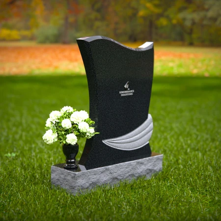 Elegant granite headstones with flowing contoured design and flower vase.