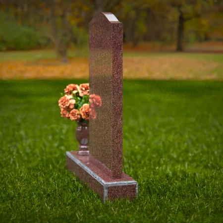 Modern upright headstones with gentle curves and vase tribute.