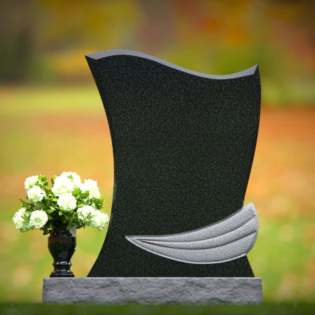 Elegant granite headstones with flowing contoured design and flower vase.