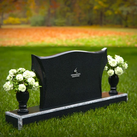 Elegant headstones with sculpted wave design and dual floral vases.