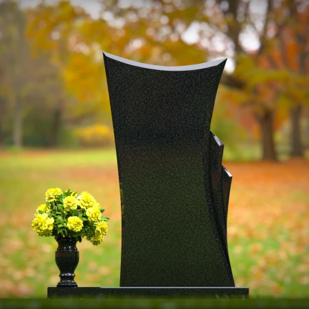 Contemporary granite memorial headstones with unique curved design.