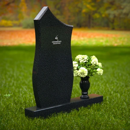 Modern contoured granite headstones with single flower vase.