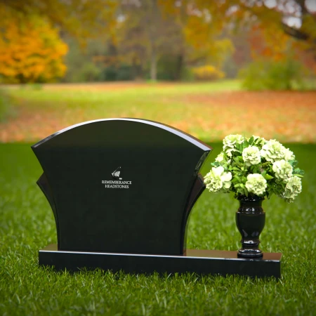 Unique headstones featuring artistic arch designs and floral vases.