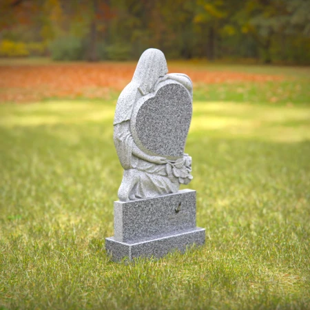 Heart-shaped gray granite headstone with angel design — a touching memorial tribute.