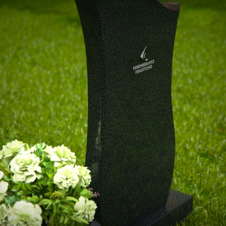 Contemporary granite headstones with unique curved design and vase.