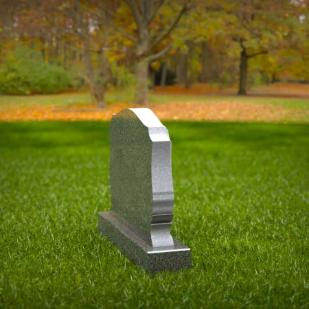 Memorial artistry flows through heart and leaf designs in headstones