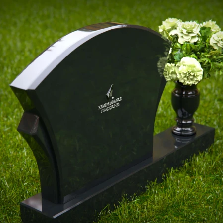 Unique headstones featuring artistic arch designs and floral vases.
