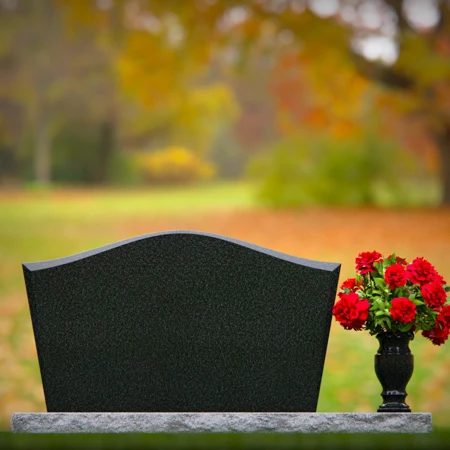 Waved granite headstones with single flower vase for graceful tribute.