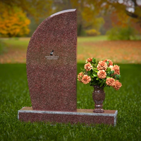 Contemporary headstones featuring sleek curves and floral vases.
