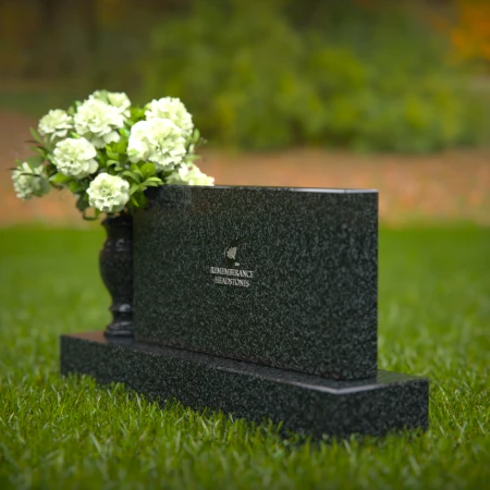 Elegant headstones featuring custom memorial designs and flower vases.
