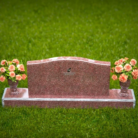 Artistic wave-top headstones with twin floral vases.