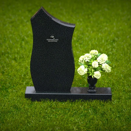 Modern contoured granite headstones with single flower vase.